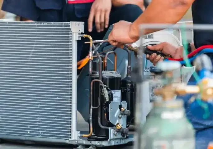 ASM technician servicing commercial HVAC equipment