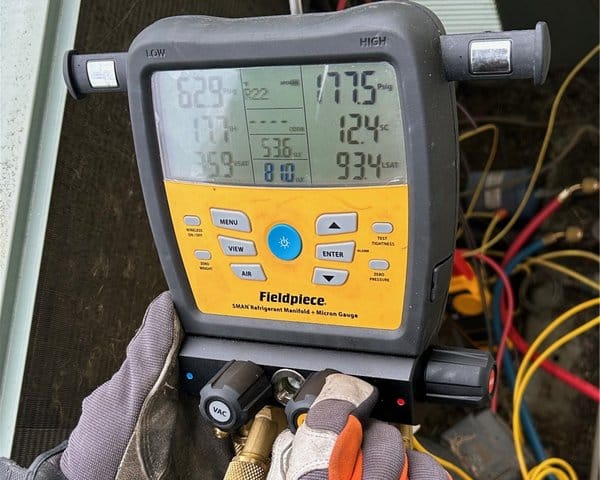 Mechanical contractor CT performing HVAC service with Fieldpiece digital gauge.